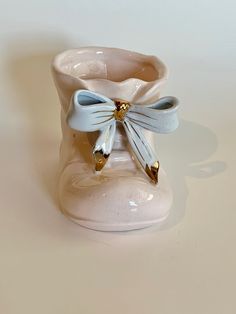 a ceramic shoe with a bow on it