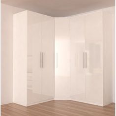 an empty room with white closets and wood flooring in front of the wall