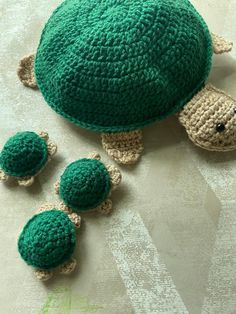 a crocheted turtle and three smaller turtles