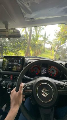 a person driving a car with their hands on the steering wheel