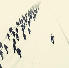 a large group of people are walking in the snow