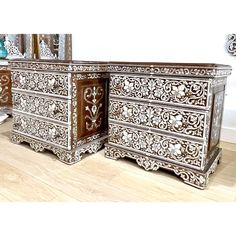 an ornate white and brown chest of drawers