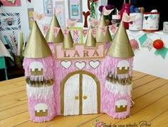 a pink and gold princess castle made out of paper