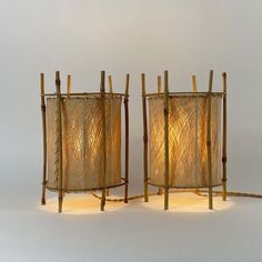 two lamps made out of bamboo sticks and rope