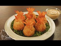 three appetizers on a plate with dipping sauce