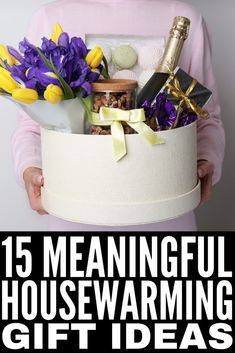 a woman holding a gift box with flowers and wine in it that says, 15 meaningful housewarming gift ideas