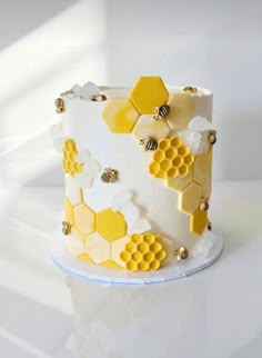 a white and yellow cake with honeycombs on it