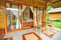 an outdoor area with wooden furniture and sliding glass doors