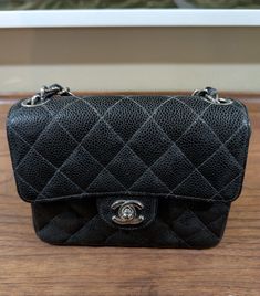 This CHANEL Mini Quilted Black Caviar Flap Bag is a must-have for any fashion-forward woman. The bag features a solid pattern and is made of high-quality leather with a gold hardware color. The bag has a turn lock closure and a black leather handle/strap with metal accents. The bag is 7 inches wide and 3 inches deep, making it the perfect size for carrying your essentials. The bag comes with an authentication card and features inner pockets, a chain strap, and pockets. The unicorn theme adds a touch of fun to the bag, making it perfect for any occasion. This bag is part of the CHANEL Mini product line and is sure to impress. Please let me know if you would like additional pictures or have any questions. Shipped with insurance and signature. Chanel Mini, Unicorn Theme, Black Caviar, The Unicorn, Metal Accents, Mini Quilt, Metallic Accents, Flap Bag, Solid Pattern