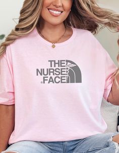 a woman wearing a pink t - shirt that says the nurse face