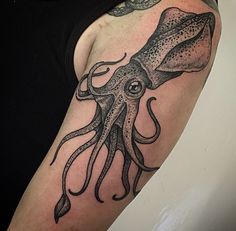 an octopus tattoo on the arm and shoulder