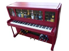 a red piano with bottles on it