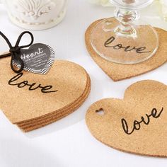 cork heart shaped coasters with the word love written on them, tied to a table