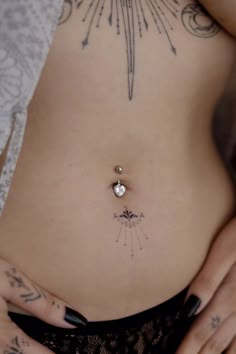 a close up of a person with tattoos on her stomach and an arrow in the middle