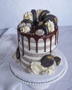 an oreo cookies and cream cake with chocolate drizzled on the top