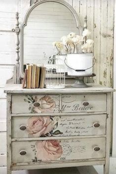 an old dresser with flowers painted on the drawers and a mirror above it that says we love you