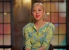 a woman with blonde hair sitting in a chair