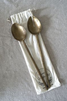 two spoons sitting on top of a white towel