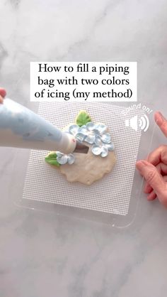 someone is decorating a cookie with icing and piping on the back of it