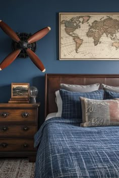 a bed room with a neatly made bed and a fan on the wall above it