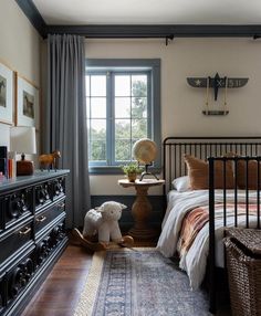 a bed room with a neatly made bed and a teddy bear