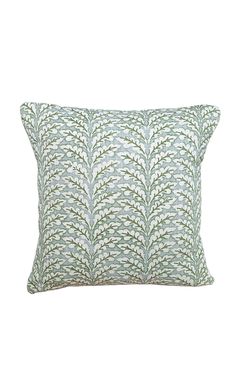 a green and white pillow with wavy leaves on the front, against a white background