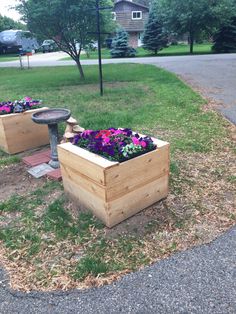 two wooden planters sitting on top of a grass covered field