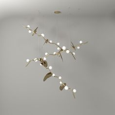 a group of lights hanging from the ceiling in a room with grey walls and flooring