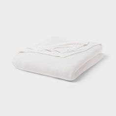 two white blankets stacked on top of each other