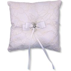 a white lace pillow with a bow on it's side and ribbon around the edge