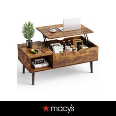 a coffee table with an open drawer underneath it and a laptop computer on the top