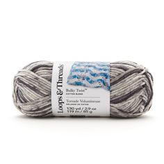 a ball of yarn with blue and white designs on the top, in grey tones