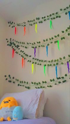 a bed with a stuffed animal sitting on top of it next to a string of lights