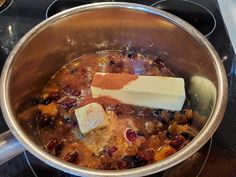 a pot filled with food sitting on top of a stove next to a burner