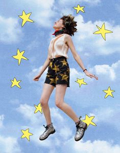 a woman is flying through the air with stars on her chest and shoes in front of her