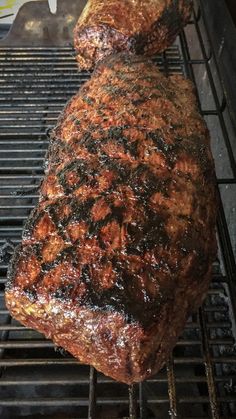 a large steak is cooking on the grill