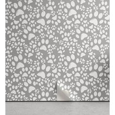 an animal print wallpaper with white and grey paw prints on the side of it