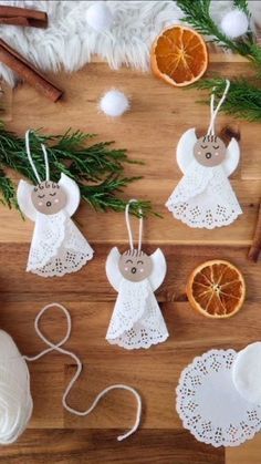 christmas ornaments are arranged on a table with orange slices and cinnamons next to them