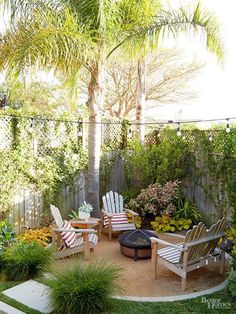 an outdoor patio with chairs and trees in the back yard, surrounded by plants and flowers