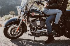 a man and woman are sitting on a motorcycle