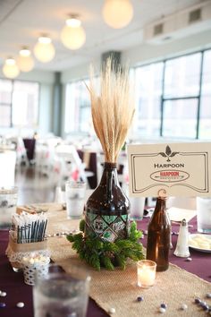 the table is set up with bottles and candles for guests to sit down at it