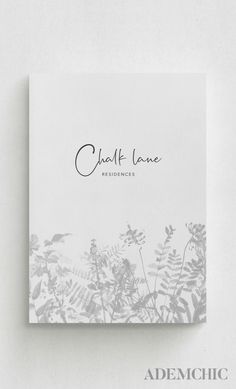 the front cover of a book with an image of plants and leaves in black ink