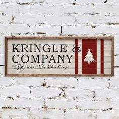 a brick wall with a sign on it that says kringle & company and a christmas tree