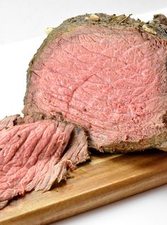 a piece of meat sitting on top of a wooden cutting board