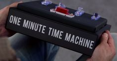 a man is holding a box that says one minute time machine