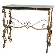 an antique console table with black marble top and gold leaf designs on the legs, against a white background