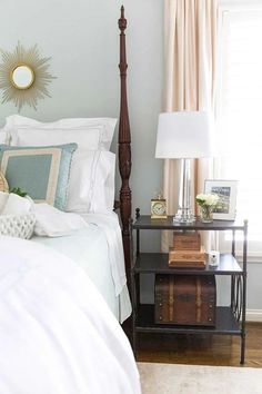 a bedroom with a bed, nightstand and window