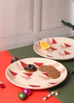 two plates with christmas cookies on them