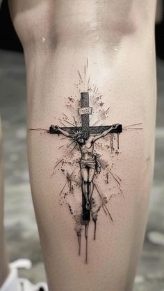 a tattoo on the leg of a person with a cross