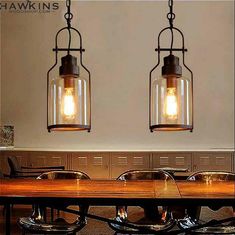 two light fixtures hanging over a wooden table